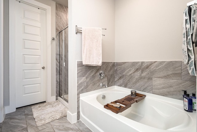 bathroom featuring independent shower and bath