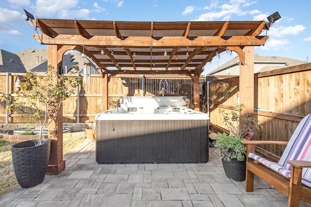 view of patio with a pergola and a hot tub