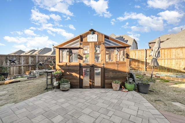 exterior space featuring a patio and an outdoor structure