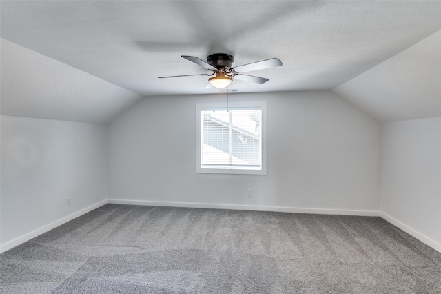 bonus room featuring vaulted ceiling, ceiling fan, carpet flooring, and baseboards