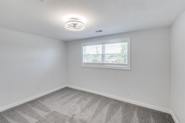 carpeted empty room with baseboards and visible vents