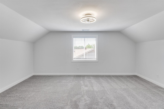 bonus room with visible vents, baseboards, vaulted ceiling, and carpet flooring