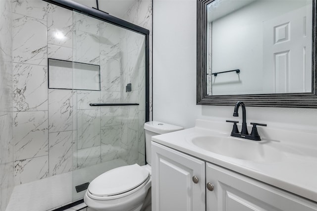 bathroom featuring vanity, a marble finish shower, and toilet