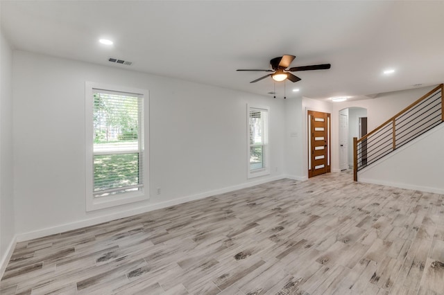 unfurnished living room with ceiling fan and light hardwood / wood-style floors