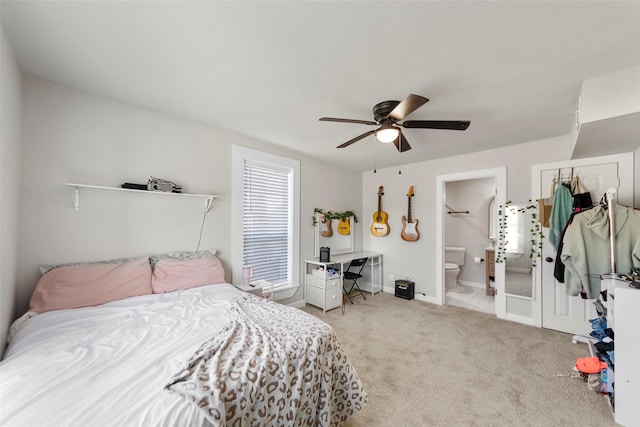 carpeted bedroom with ceiling fan and ensuite bathroom