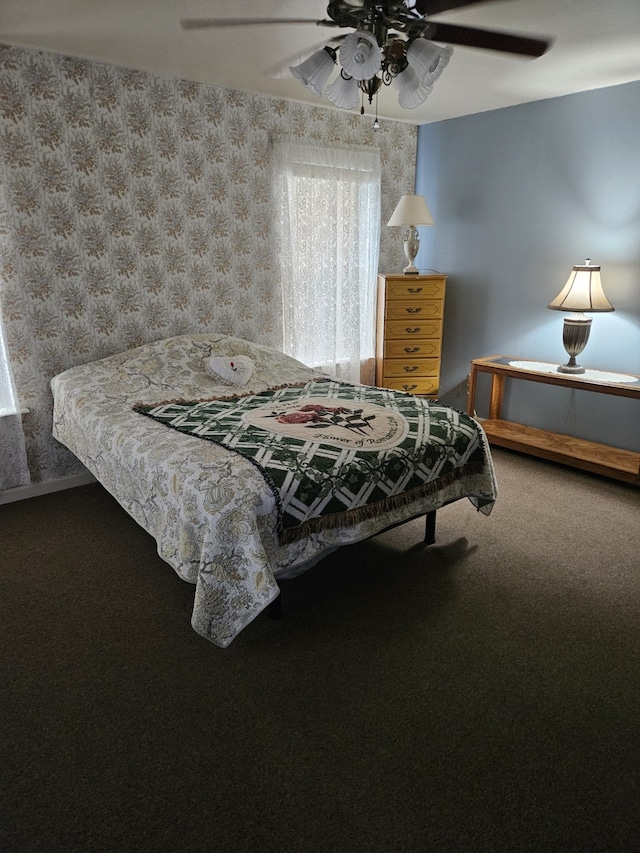 bedroom featuring ceiling fan and carpet