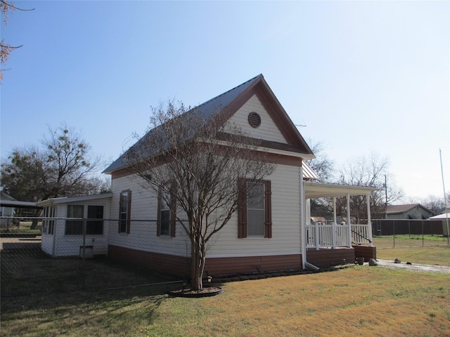 view of property exterior with a porch and a lawn