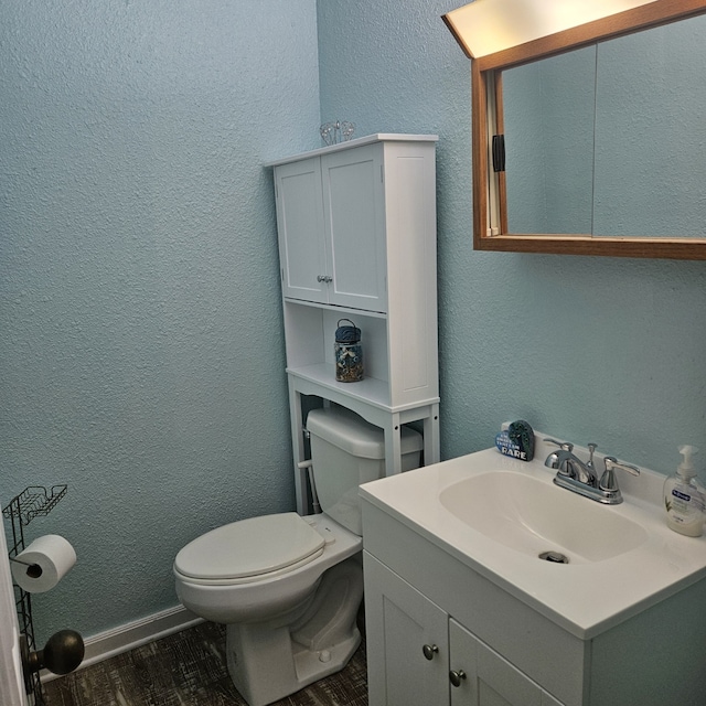 bathroom with vanity, hardwood / wood-style floors, and toilet