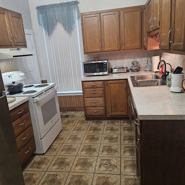 kitchen with sink, white electric range oven, and backsplash