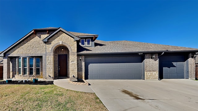 view of front of house with a garage and a front lawn