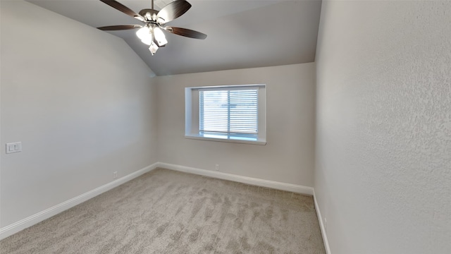 carpeted spare room with lofted ceiling and ceiling fan