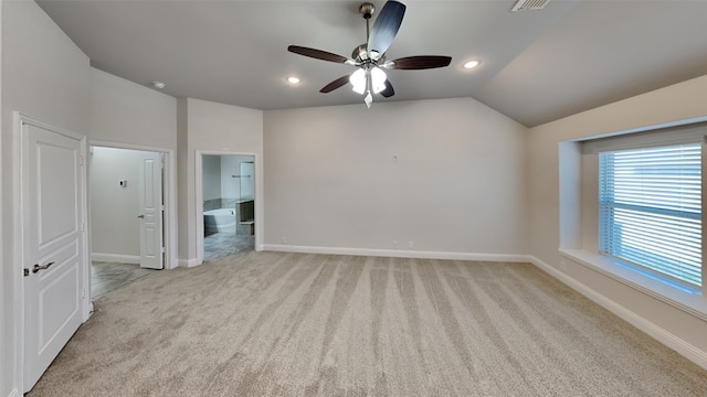 spare room with light carpet, lofted ceiling, and ceiling fan