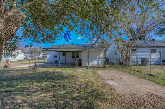 back of house with a lawn