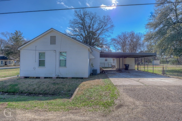 view of property exterior with a carport and central air condition unit