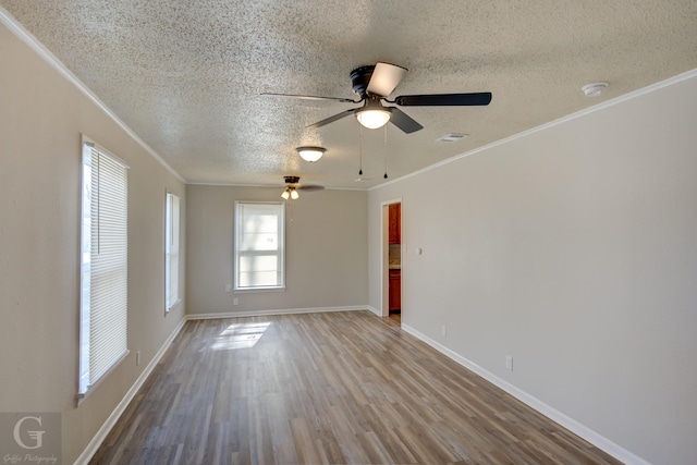 spare room with crown molding, ceiling fan, a textured ceiling, and light wood-type flooring