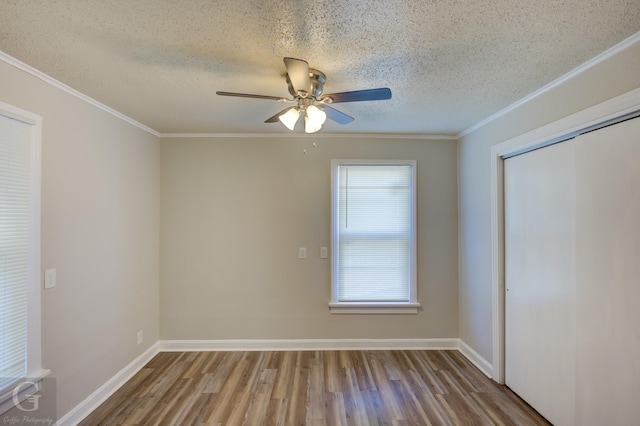 unfurnished room with hardwood / wood-style flooring, crown molding, ceiling fan, and a textured ceiling