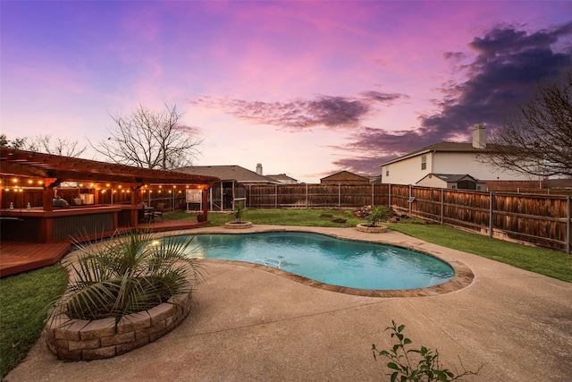 pool at dusk featuring a hot tub, a deck, and a patio area