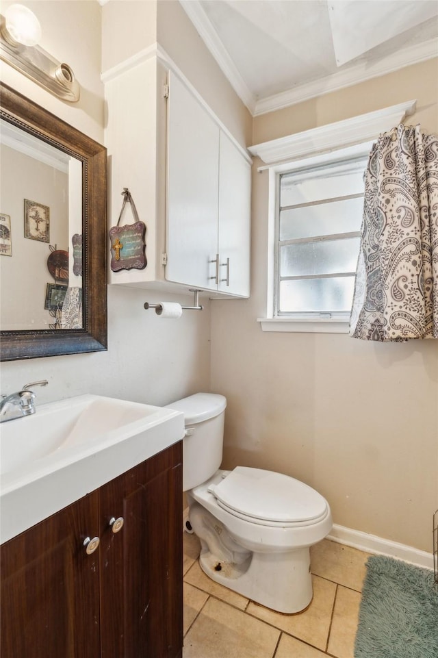 bathroom with vanity, ornamental molding, tile patterned floors, and toilet