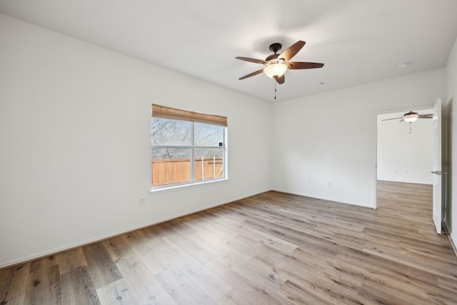 empty room featuring ceiling fan and light hardwood / wood-style flooring