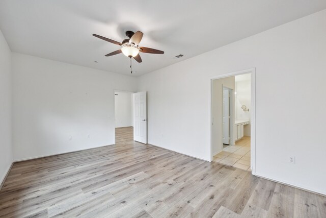 spare room featuring ceiling fan and light hardwood / wood-style floors