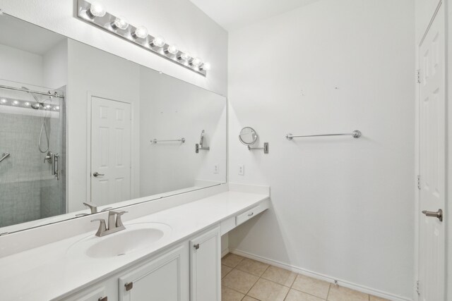 bathroom featuring vanity, a shower with shower door, and tile patterned floors