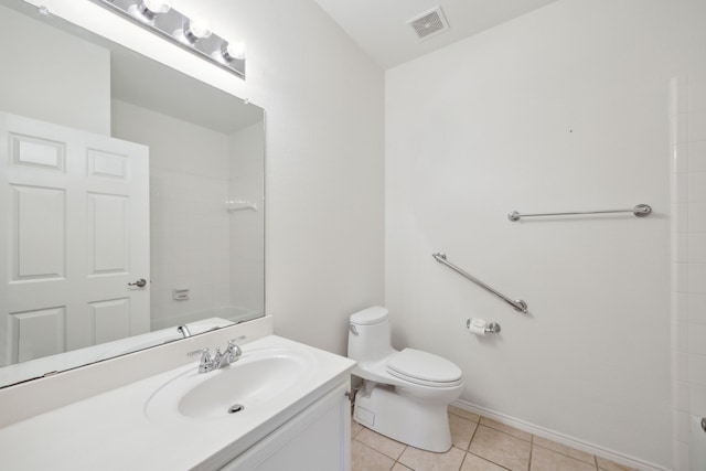 bathroom with vanity, tile patterned floors, and toilet