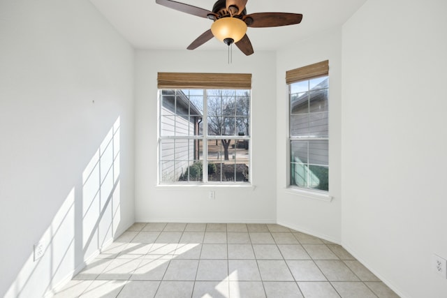 tiled spare room with ceiling fan