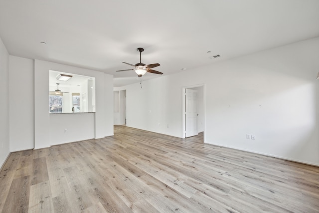 unfurnished living room with ceiling fan and light wood-type flooring