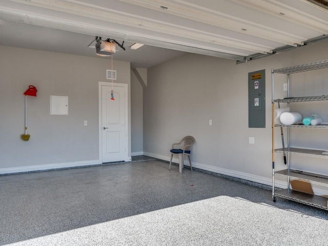 garage with visible vents, baseboards, electric panel, and a garage door opener