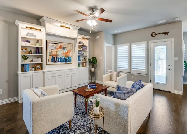 living room with ceiling fan and dark hardwood / wood-style flooring