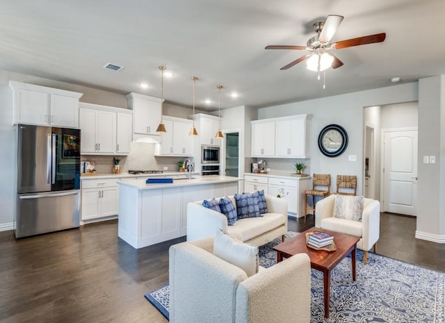 living room featuring dark hardwood / wood-style floors and ceiling fan