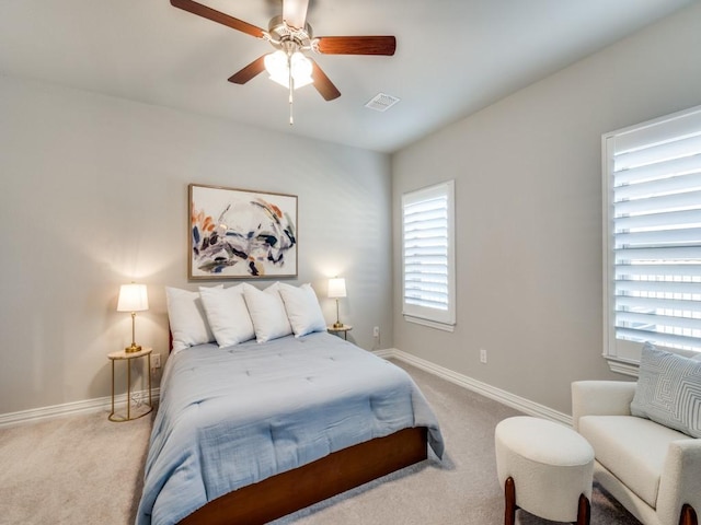 bedroom with a ceiling fan, carpet, visible vents, and baseboards