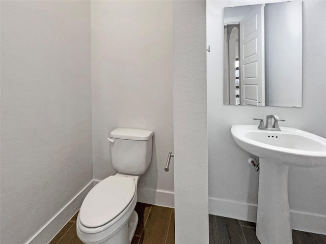 bathroom featuring sink, hardwood / wood-style flooring, and toilet