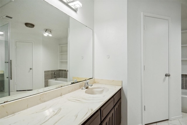 bathroom with vanity and a washtub