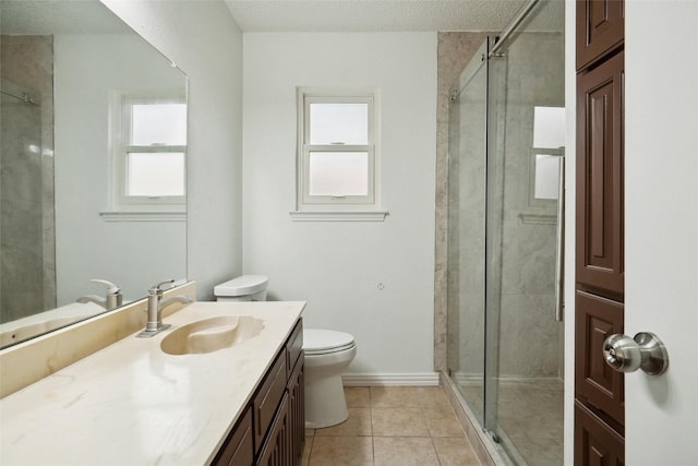 bathroom with vanity, tile patterned flooring, toilet, and walk in shower