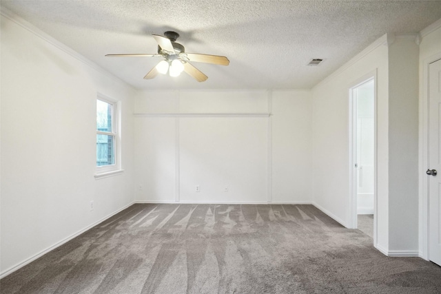 unfurnished room featuring ornamental molding, carpet, a textured ceiling, and ceiling fan