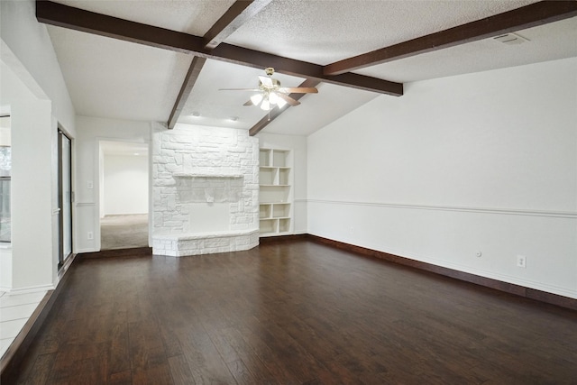 unfurnished living room featuring ceiling fan, vaulted ceiling with beams, dark hardwood / wood-style floors, a fireplace, and a textured ceiling