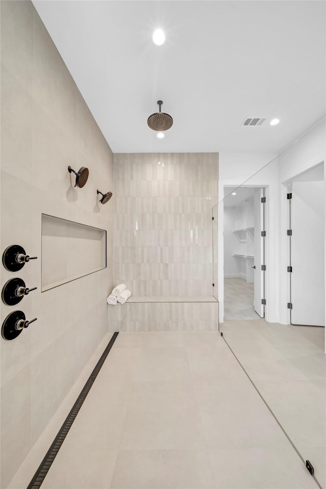 bathroom featuring tile patterned flooring and tiled shower