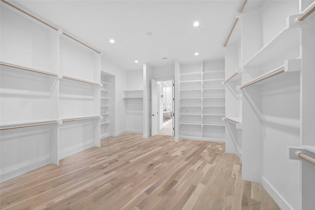 spacious closet with light hardwood / wood-style floors