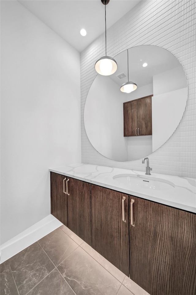 bathroom featuring vanity, recessed lighting, baseboards, and visible vents