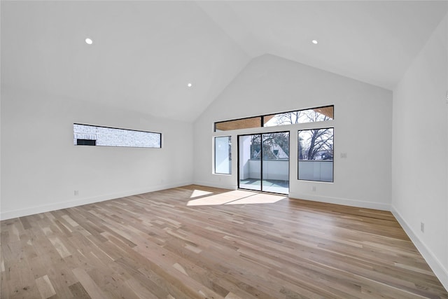 spare room with recessed lighting, baseboards, light wood-style floors, and high vaulted ceiling