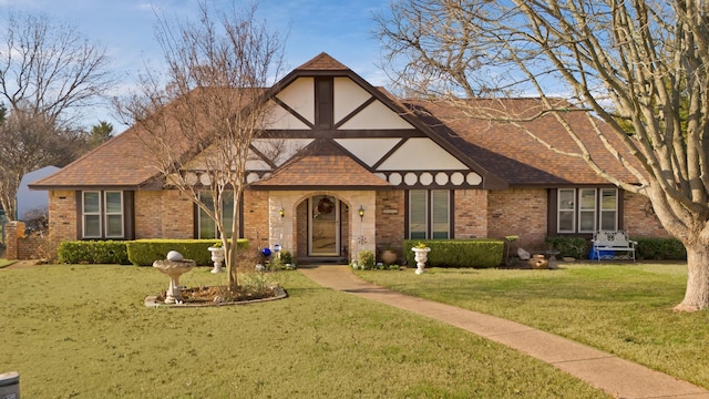 tudor-style house with a front yard