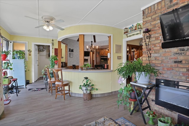 kitchen with hardwood / wood-style flooring and ceiling fan with notable chandelier