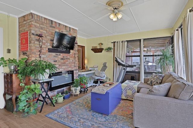 living room with ceiling fan, wood-type flooring, and a wealth of natural light