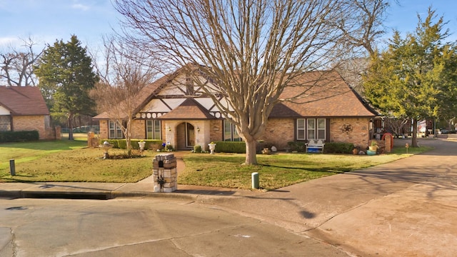 english style home with a front yard