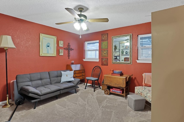 carpeted living room with ceiling fan and a textured ceiling