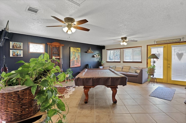 rec room with pool table, a textured ceiling, ceiling fan, and light tile patterned flooring