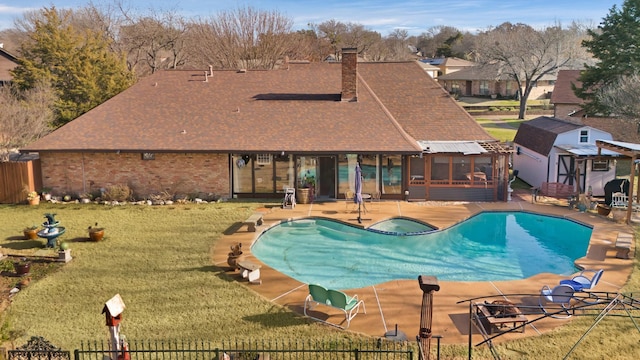 view of swimming pool featuring an in ground hot tub, a patio area, and a lawn