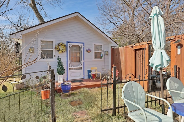 view of front of property with a wooden deck and a front yard