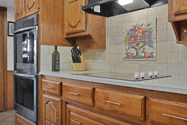 kitchen featuring backsplash, black electric stovetop, double oven, and exhaust hood